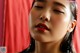 A close up of a woman's face with her eyes closed.